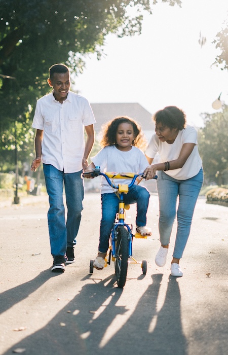 parents with child on bike
